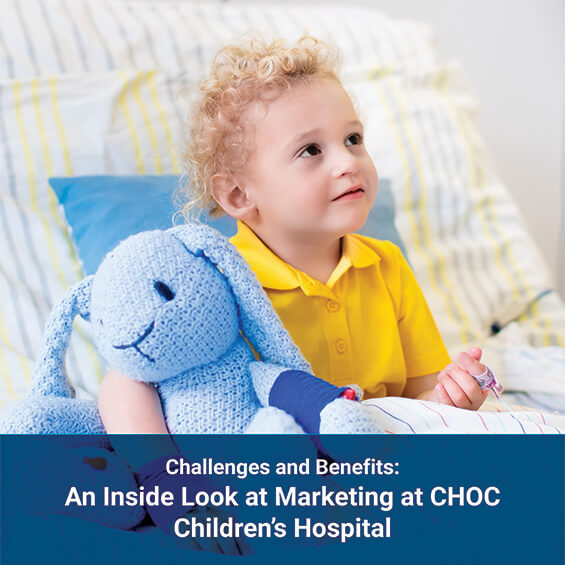 A child sitting on a hospital bed with a stuffed animal