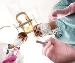 Two dental surgeons looking over patient