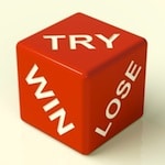 3 sides of red dice reading "Win, Try, Lose"