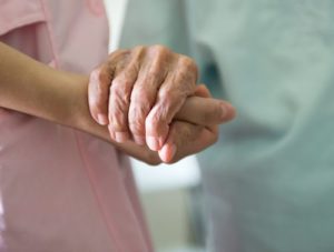 doctor holding patients hand