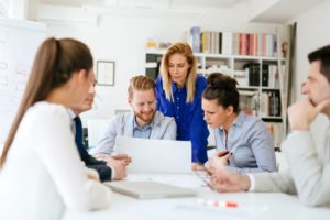 A group of employees having a team meeting in a conference room