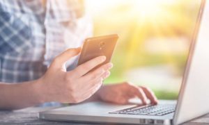 man holding phone while on medical website