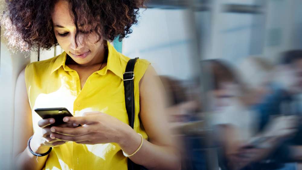 woman texting in subway