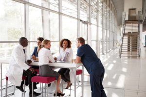 Doctors sitting around a table discussing their work