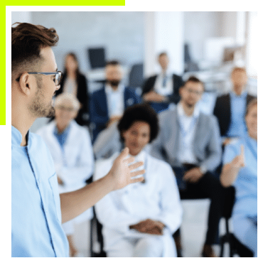 A man speaking in front of a group of people