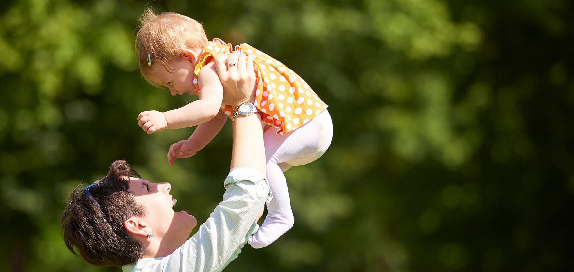 mother holding up her child