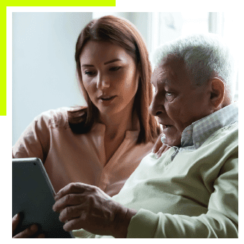 Young woman helping older man read