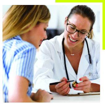 Doctor reviewing paperwork with woman